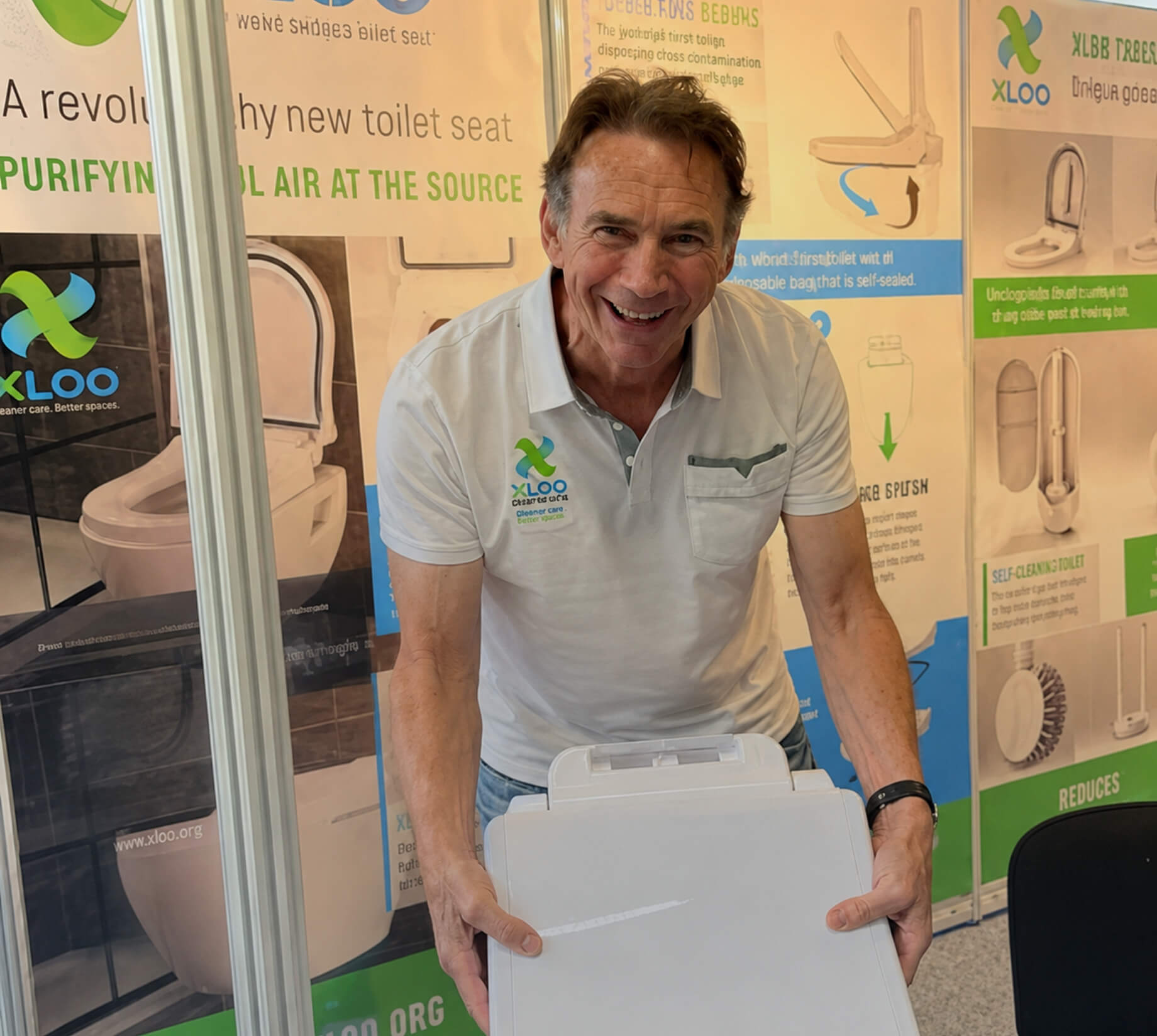 XLOO representative at the Ideal Home Show London demonstrating the XLOO Delux Seat to homeowners and business visitors